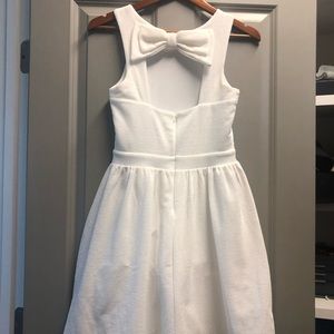 Casual white cocktail dress with bow in back